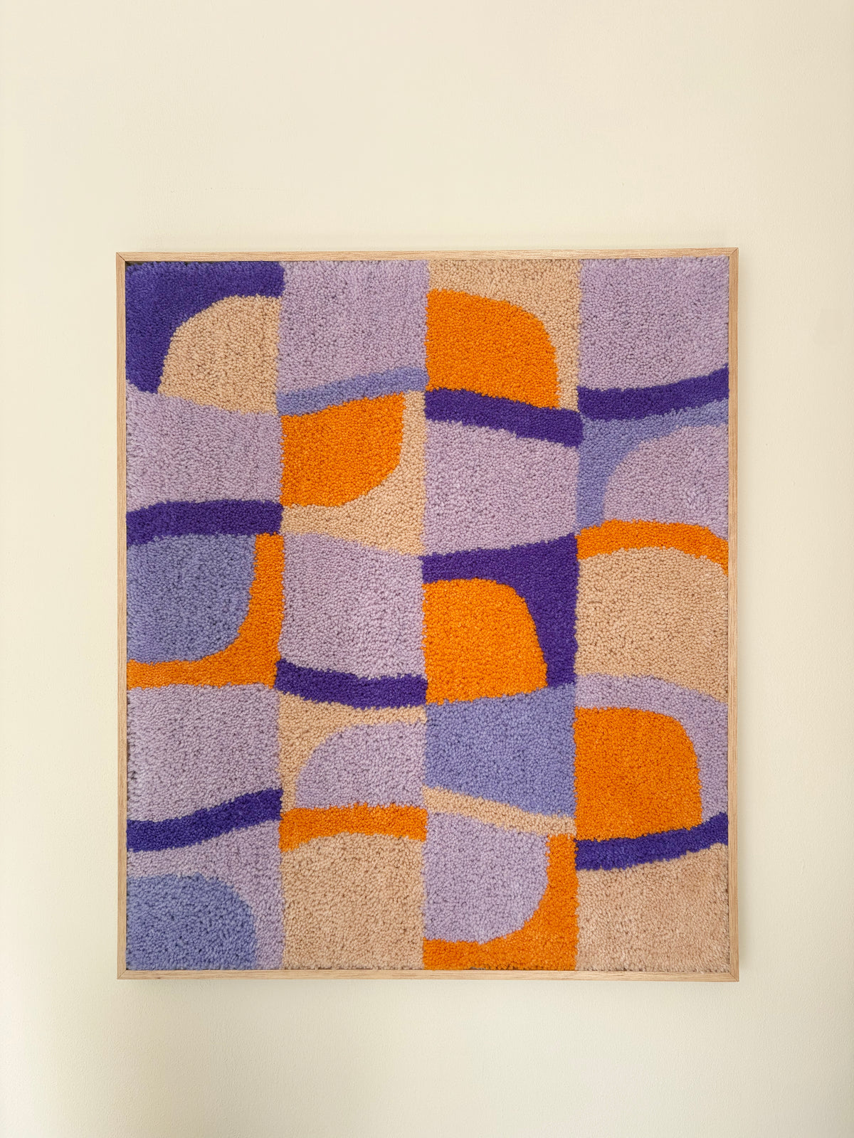 Discover a playful rhythm with Sundial Checker. Soft lavender, warm amber and sandy beige blocks interlock in a hand-tufted grid, where curved sun-like forms break through the geometry — bringing warmth and movement to a modern interior.

Handcrafted Tufted Art This piece is 100% hand-tufted using premium New Zealand wool, chosen for its rich texture, natural luster and durability. Every curve and colour block is tufted by hand, giving the surface a soft, tactile depth that a printed piece simply can't repl